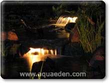 A stream at night with underwater pond lights